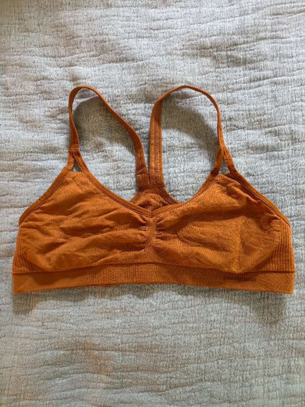 Dark orange Patagonia sports bra.
